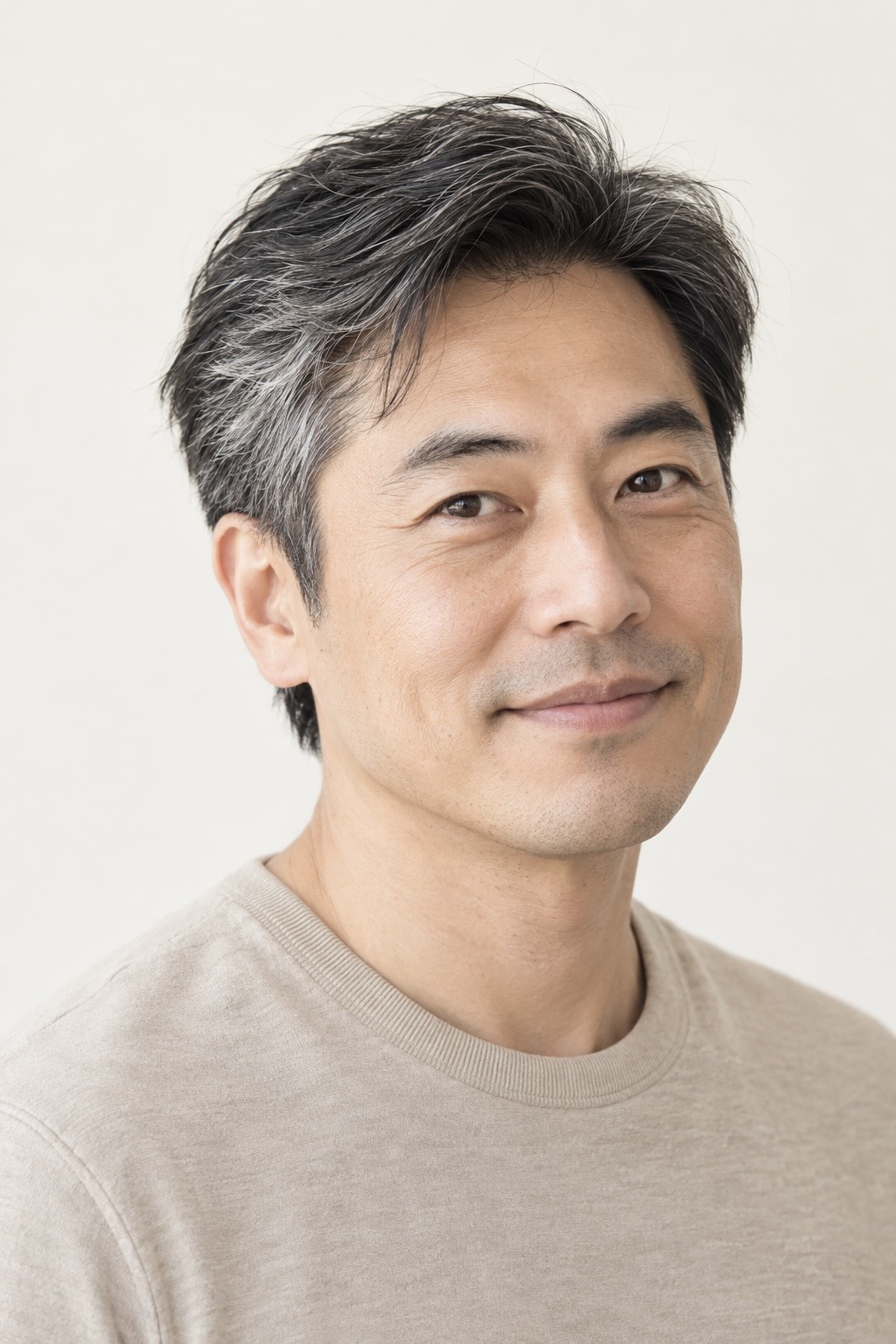 Portrait of a man with dark hair streaked with grey